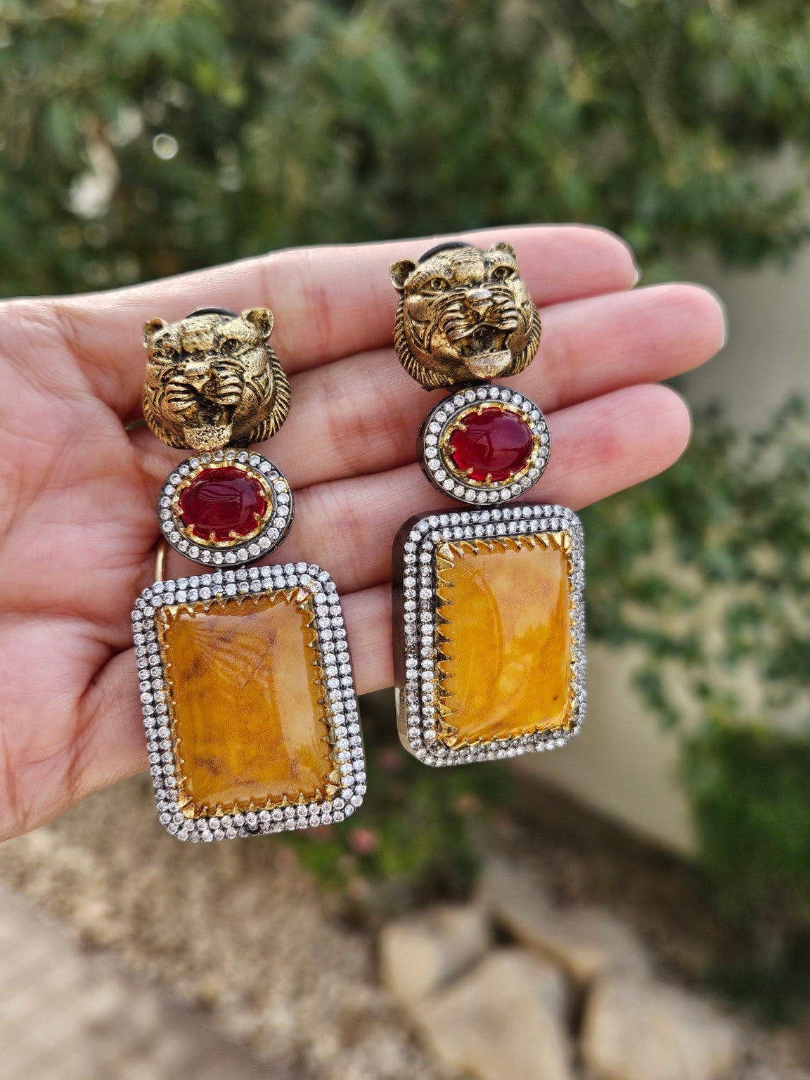 Sabya-inspired tiger head earrings in natural daylight