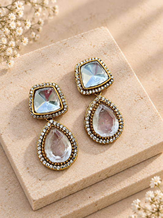 Adaa Moissanite Polki Kundan with Doublet Stone Earrings, White colour, on beige square stone with small white flowers.