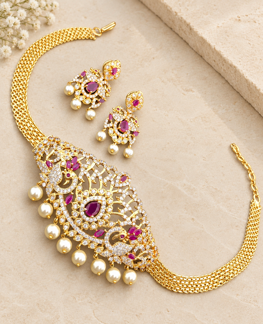 Gold-tone peacock choker and matching earrings with pink stones and pearl-style drops on beige stone.