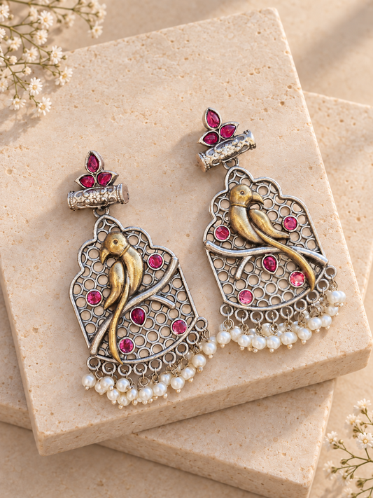 Dual-Tone Bird Drop Earrings, Dark Pink colour, on beige square stone with small white flowers.