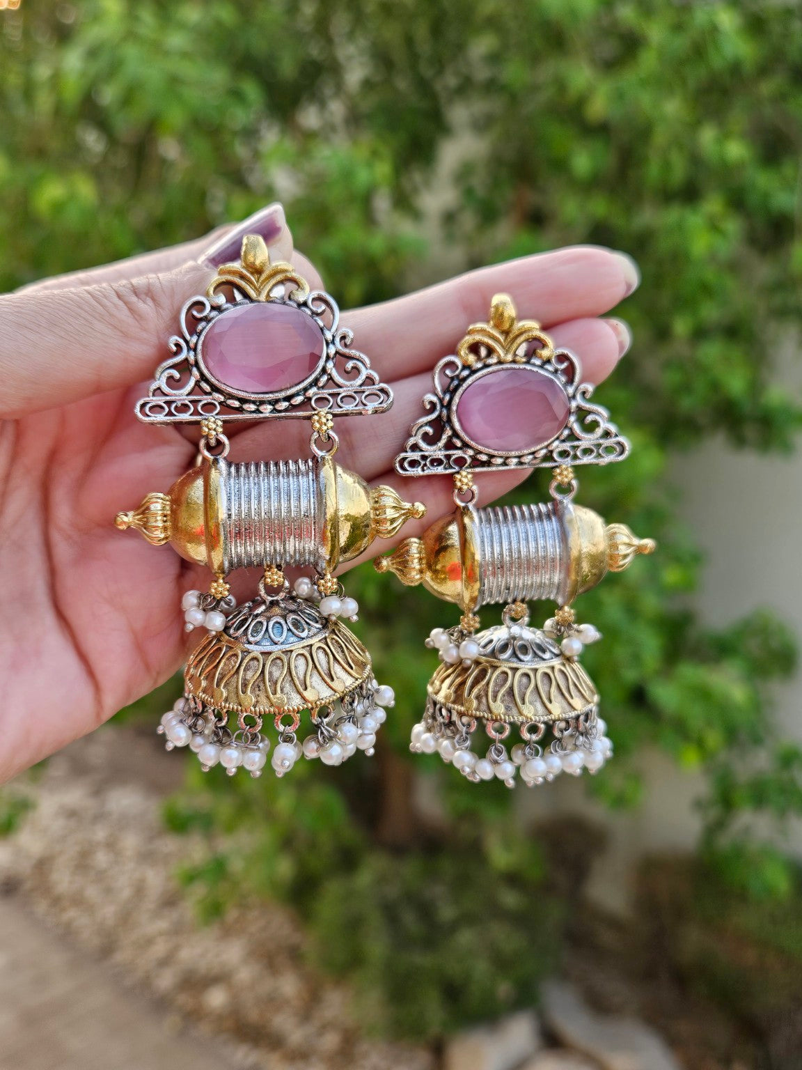 Pink center dual tone statement jhumka earrings in natural daylight