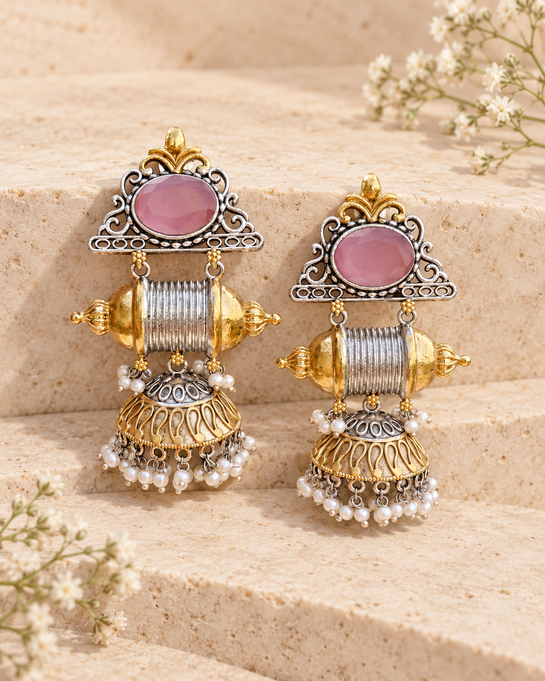 Pink center dual tone statement jhumka earrings on beige stone background