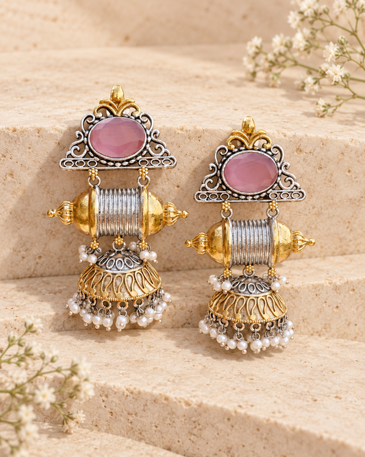 Pink center dual tone statement jhumka earrings on beige stone background