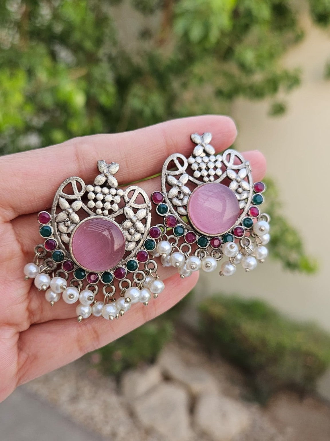 Pink floral silver lookalike earrings with Mona Lisa stone and pearls in natural daylight