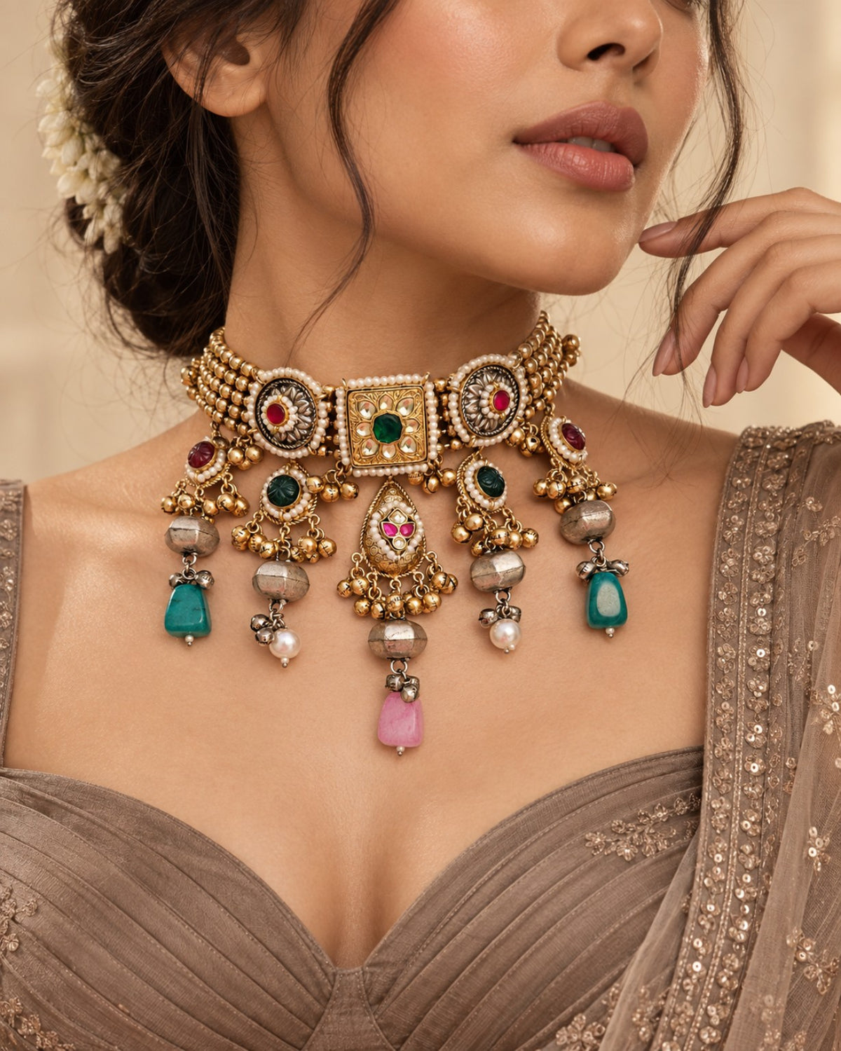 Close-up model wearing Aara gold dust polish Pachi Kundan ghungroo necklace