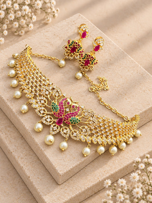 Hiranya gold-tone choker and matching earrings with clear stones and pearl drops on beige square stones.