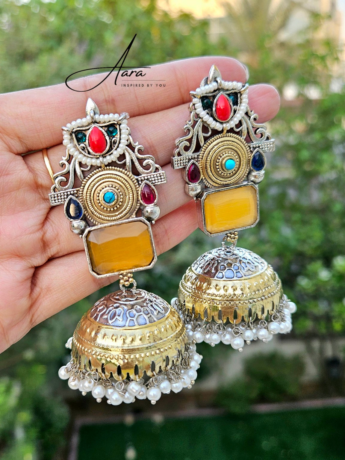 Yellow Mona Lisa stone lightweight jhumka earrings in natural daylight