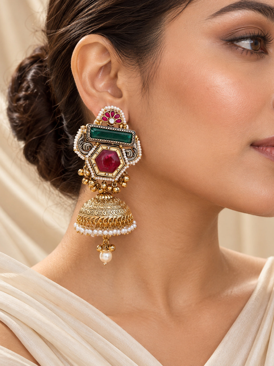 Close-up of luxury antique gold doublet stone jhumka earring on model