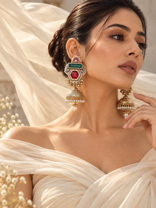 Model wearing luxury antique gold doublet stone jhumka earrings with pearl and ghungroo detailing