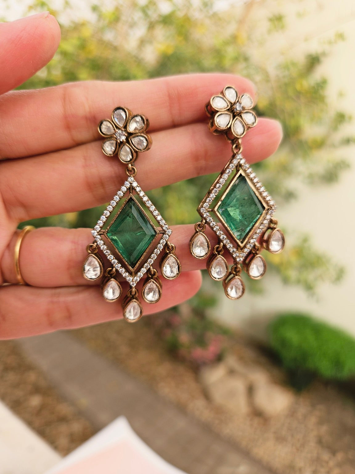 Matching mint green doublet stone and AD earrings photographed in natural daylight