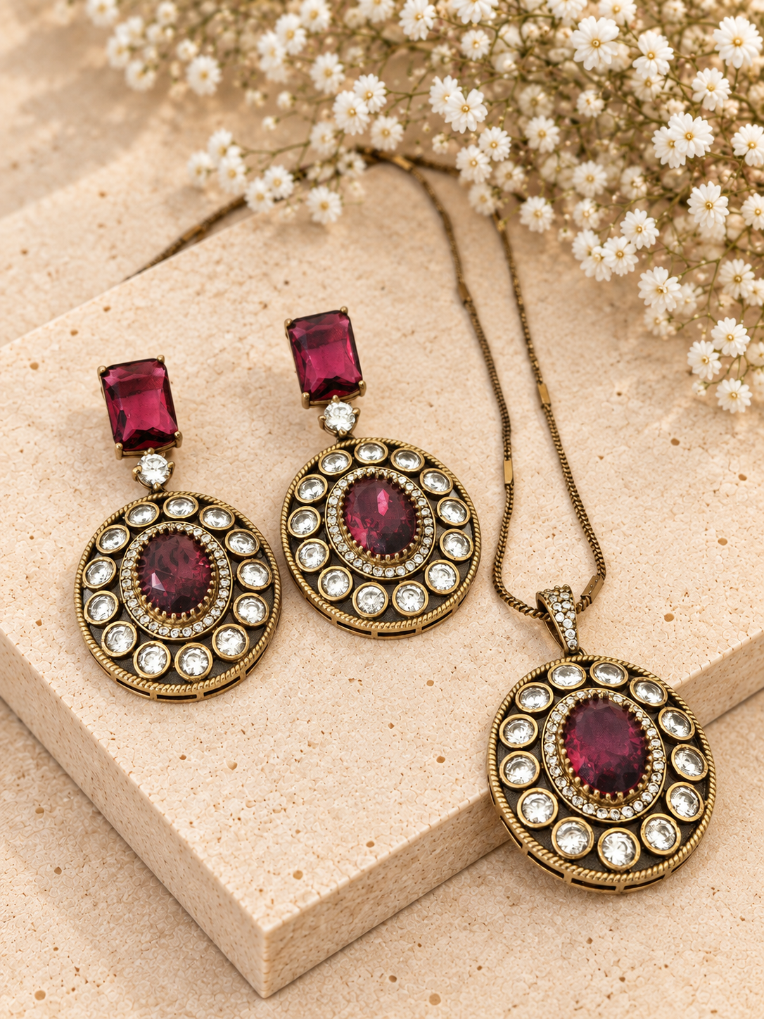 Moissanite Polki Pendant Set, Ruby Red colour, on beige square stone with small white flowers.
