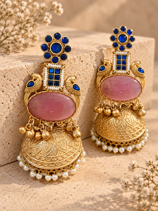 Lightweight Monalisa stone jhumka with blue stones and pink centre stone on beige stone background