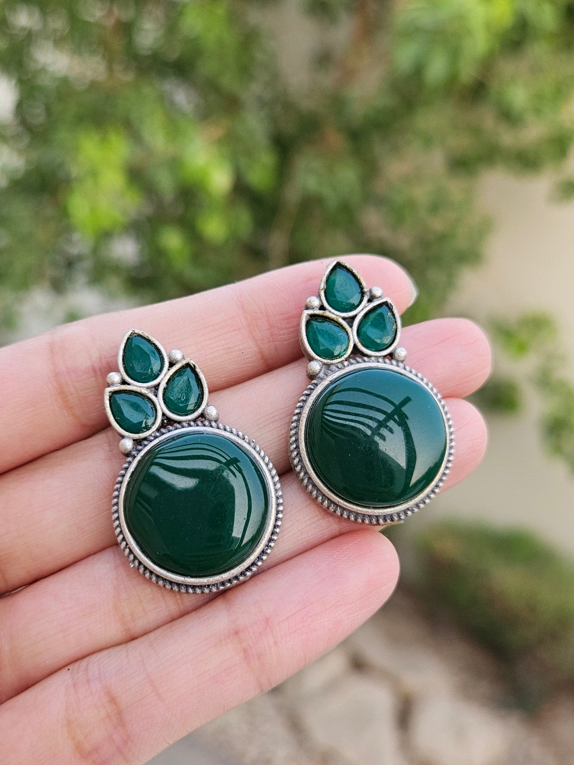 Green Mona Lisa stone stud earrings in natural daylight