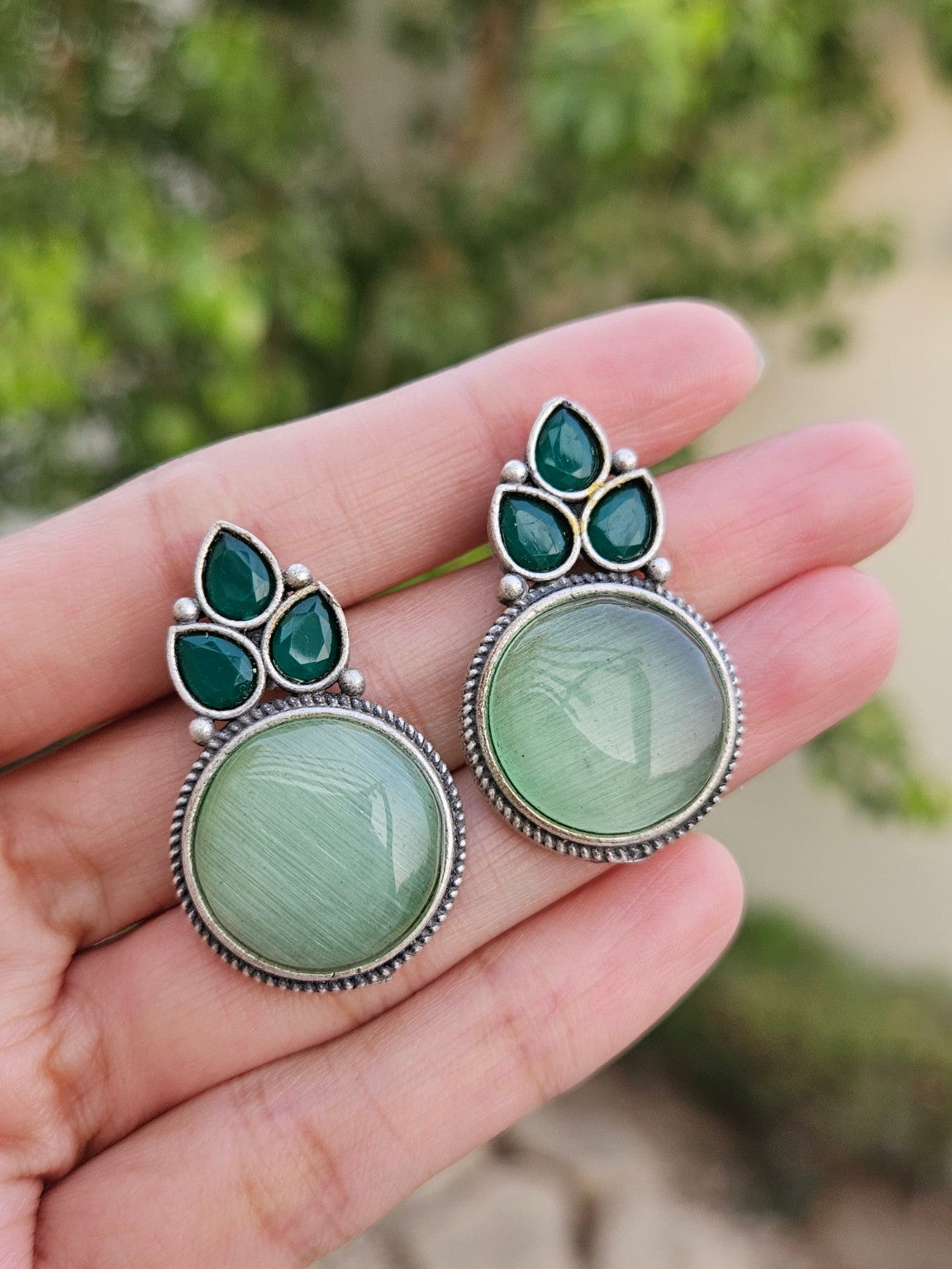 Mint Mona Lisa stone stud earrings in natural daylight