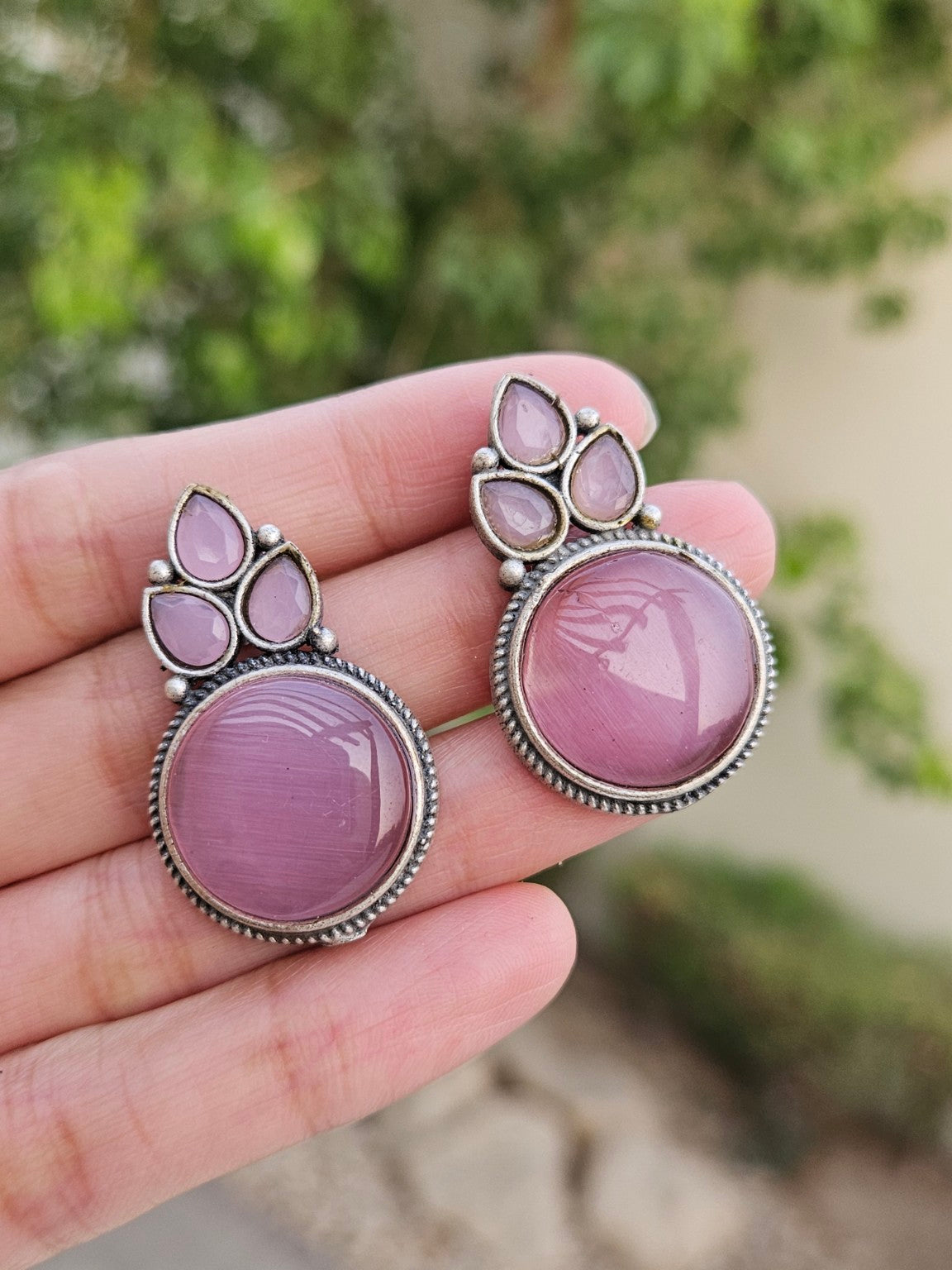 Pink Mona Lisa stone stud earrings in natural daylight