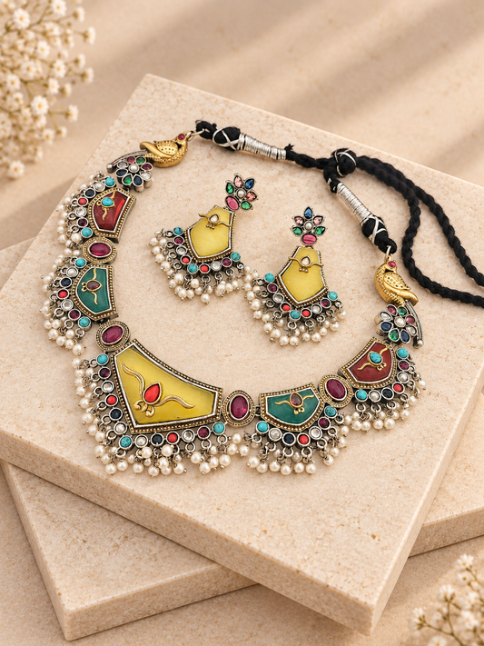 Multicolour Monalisa necklace and matching yellow-stone earrings with bead fringes on two beige square stone slabs.