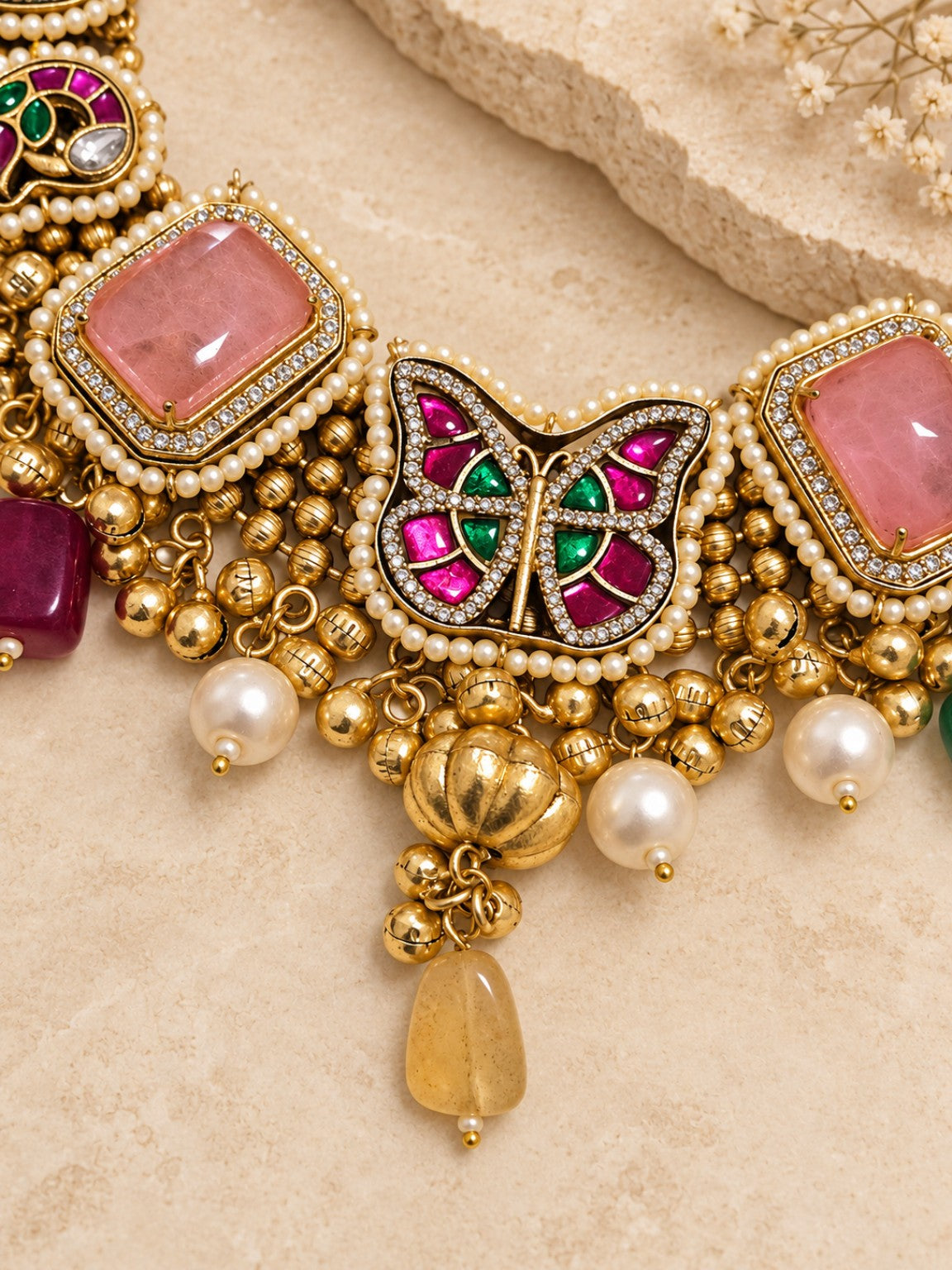 Close-up of pink Pachi Kundan doublet stone necklace with multicolor detailing and natural stone drops