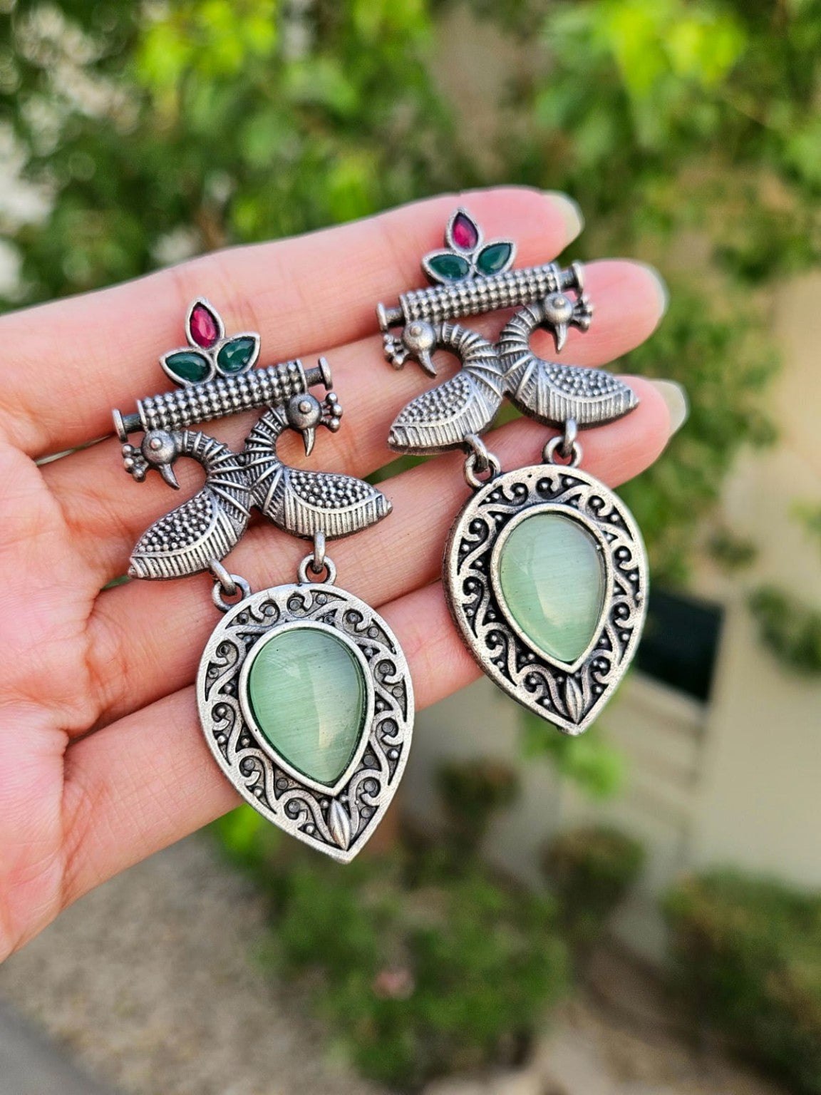 Mint peacock Mona Lisa stone earrings in natural daylight