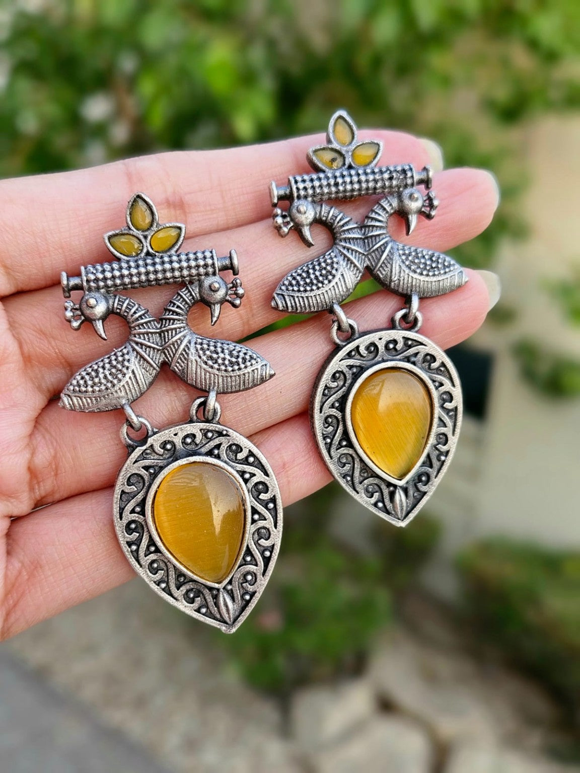 Yellow peacock Mona Lisa stone earrings in natural daylight