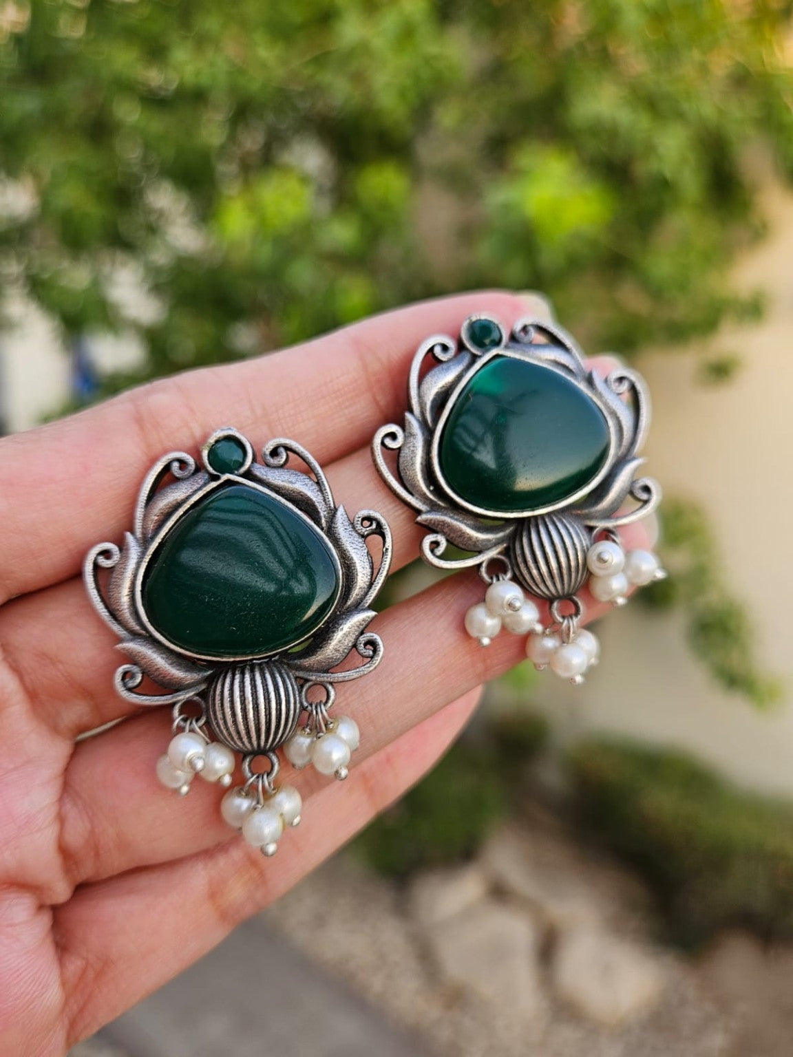 Green Mona Lisa stone silver lookalike earrings with pearl hangings in natural daylight