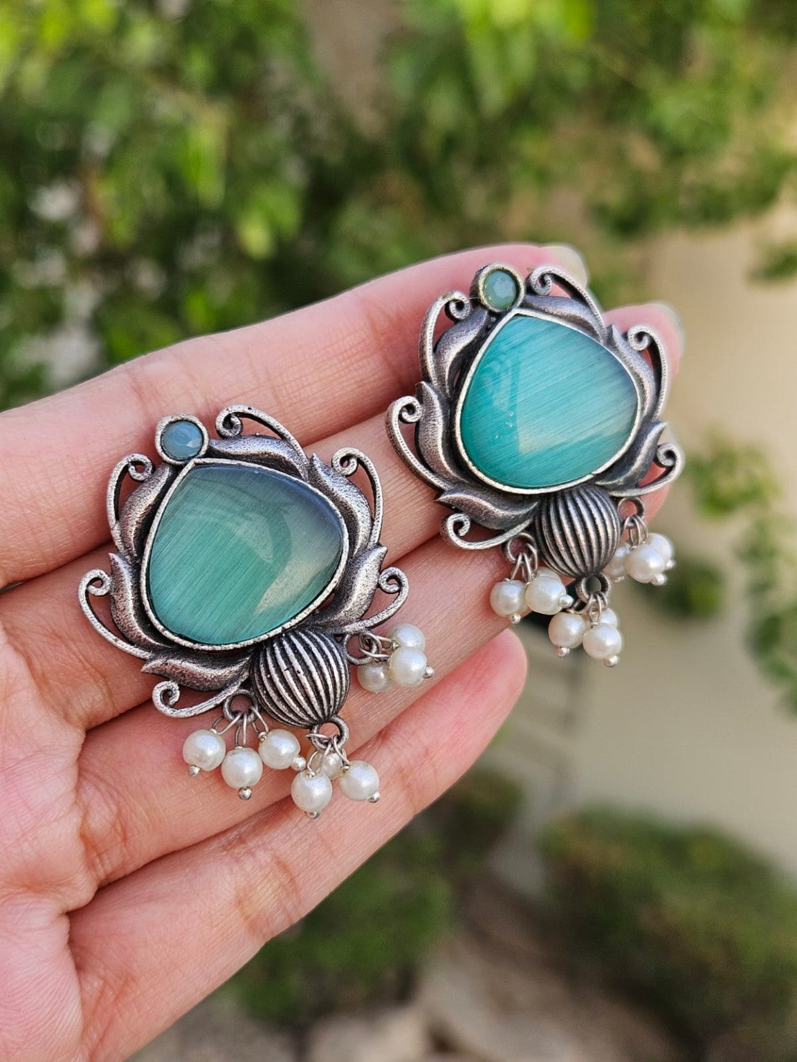 Turquoise Mona Lisa stone silver lookalike earrings with pearl hangings in natural daylight