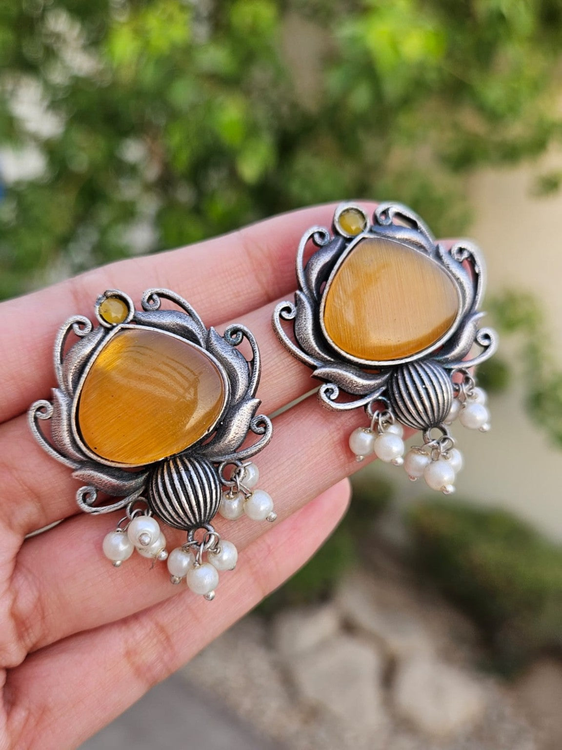 Yellow Mona Lisa stone silver lookalike earrings with pearl hangings in natural daylight