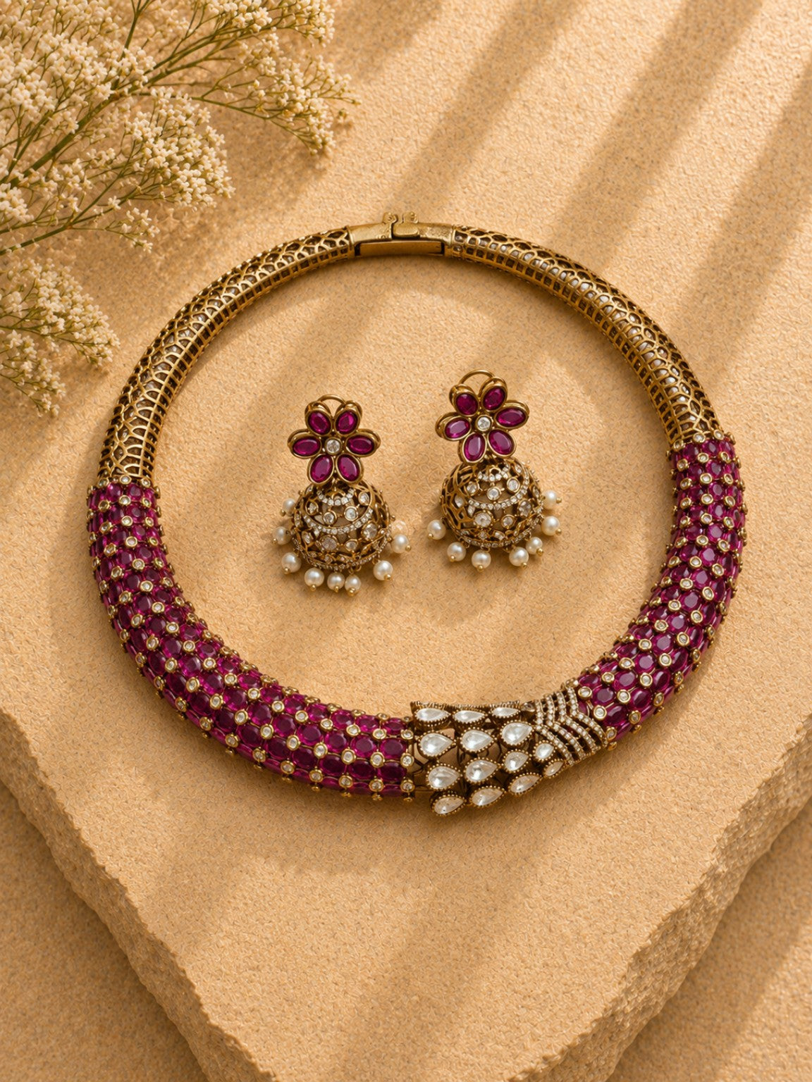 Ruby pink Moissanite Polki Kundan statement necklace set with matching jhumka on beige stone background