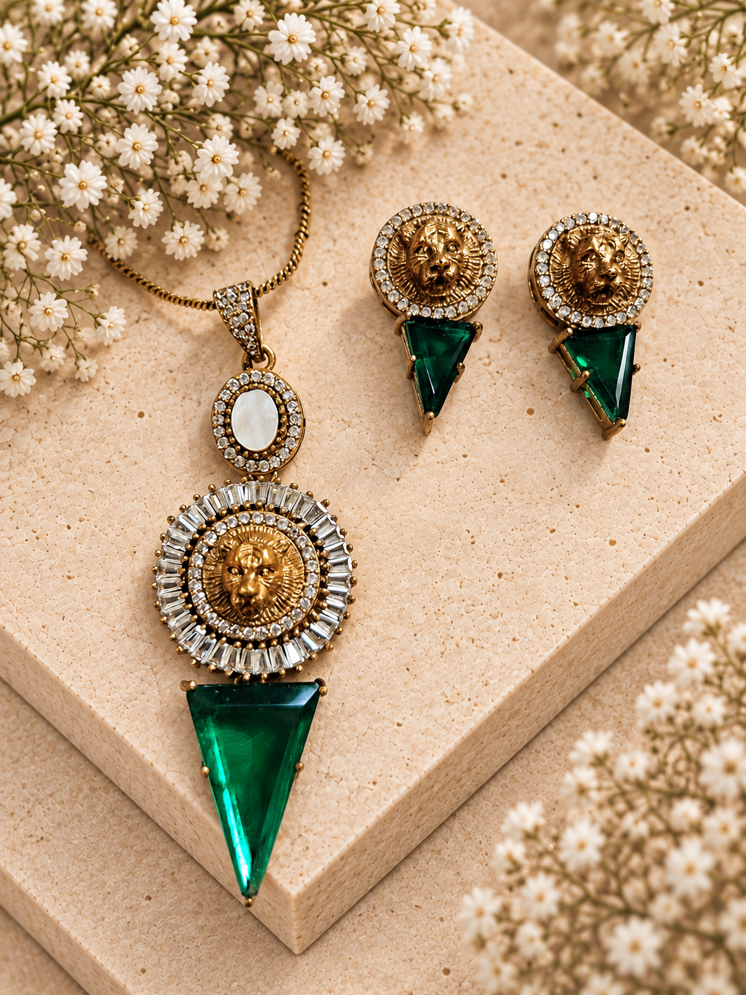 Sabya Inspired Tiger Head Pendant Set, Green colour, on beige square stone with small white flowers.