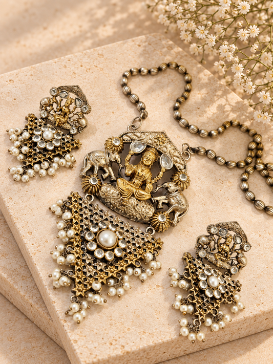 Silver Replica Dual Tone Monalisa Stone Lakshmi Pendant Set, White colour, on beige square stone with small white flowers.