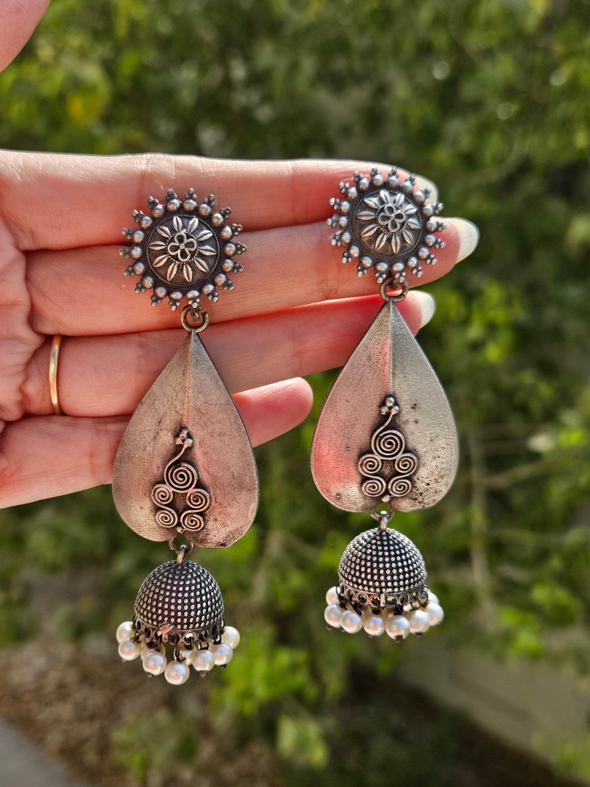 Teardrop oxidized silver lookalike jhumka earrings in natural daylight