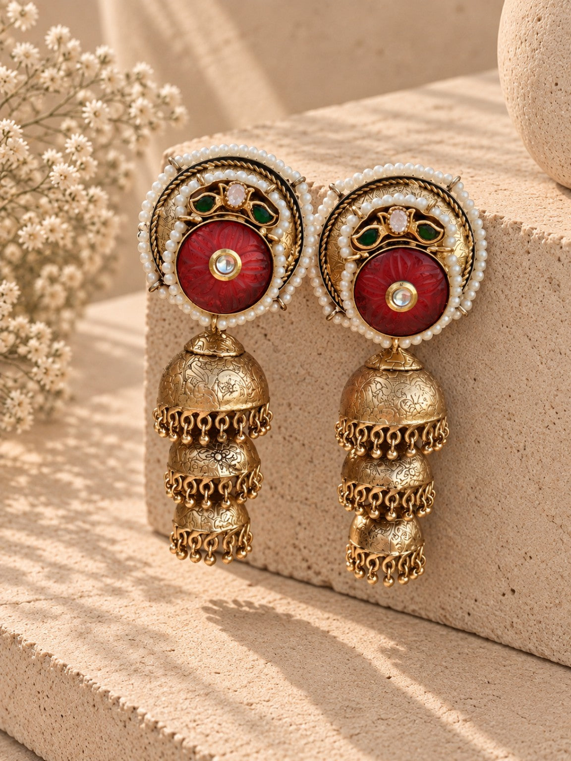 Three layer handcrafted gold dust polish jhumka with carved red stone and Pachi Kundan work by Aara Dubai
