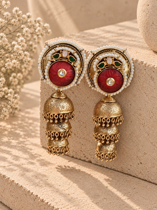 Three layer handcrafted gold dust polish jhumka with carved red stone and Pachi Kundan work by Aara Dubai