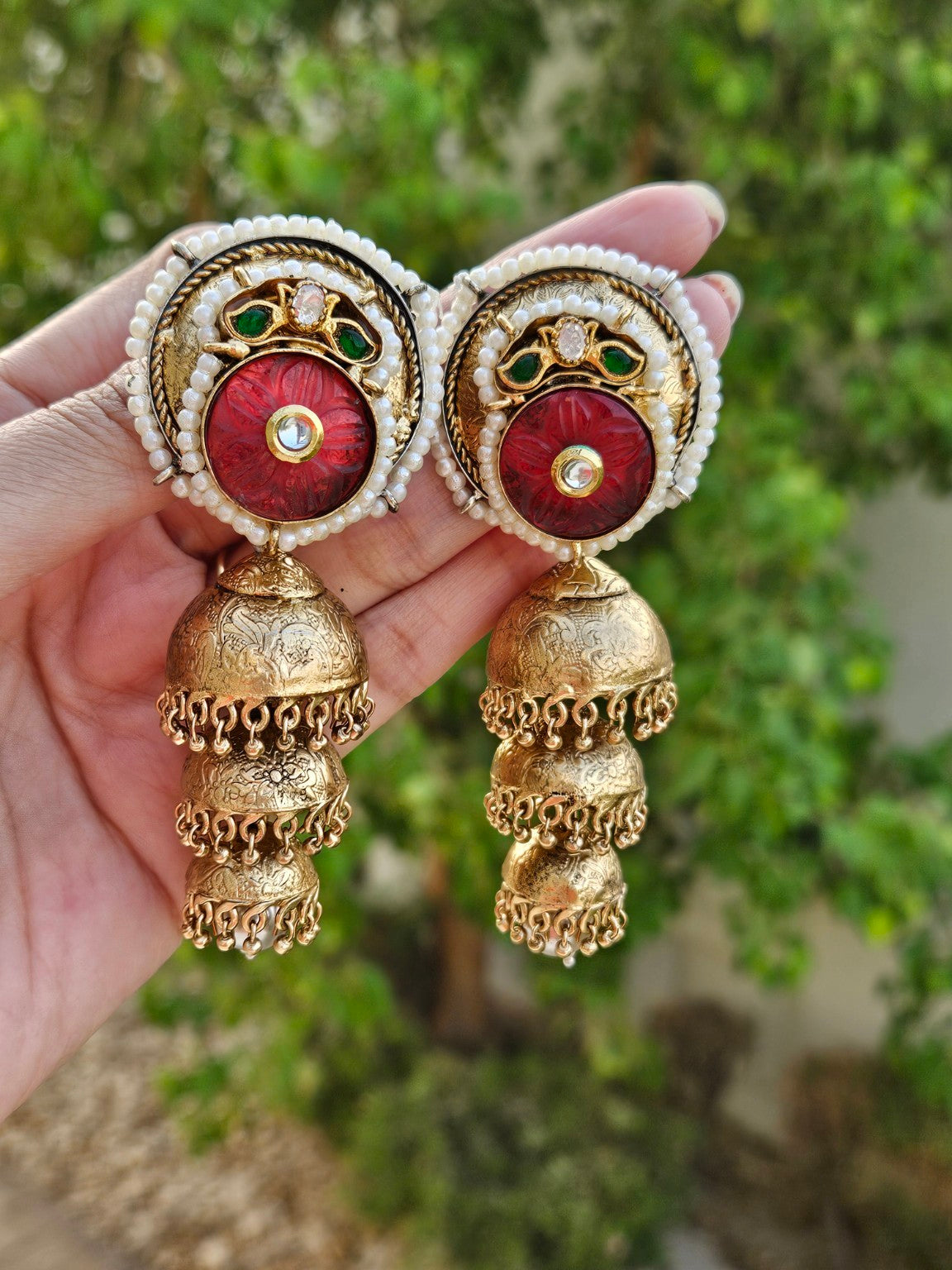 Three layer antique gold plated Pachi Kundan jhumka photographed in natural daylight
